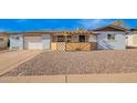 Charming one-story house with xeriscaped front yard, decorative wood accents, and attached garage at 5422 E Des Moines St, Mesa, AZ 85205