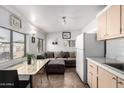 This cozy living room includes a couch, marble table, eat-in kitchen, and lots of natural light at 5422 E Des Moines St, Mesa, AZ 85205