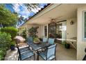 Outdoor patio showcasing dining table, chairs, ceiling fan, and lush plants at 5465 N 78Th St, Scottsdale, AZ 85250