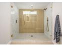 Modern bathroom features a glass-enclosed shower with gold fixtures and tiled walls at 7346 E Mckinley St, Scottsdale, AZ 85257