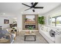 Bright living room boasts a cozy fireplace, stylish decor, and plenty of natural light at 7346 E Mckinley St, Scottsdale, AZ 85257