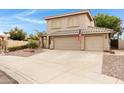Charming two-story home with a three-car garage and well-maintained landscaping at 9665 E Nido Ave, Mesa, AZ 85209