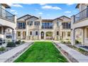 A row of beautiful two-story townhomes feature well-manicured green lawns and balconies at 9906 E Wavelength Ave, Mesa, AZ 85212