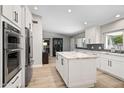 Bright, modern kitchen with white cabinets, stainless steel appliances, and a spacious island at 12411 N 57Th St, Scottsdale, AZ 85254
