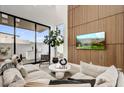 Inviting living room with a large sliding glass door to outdoor patio, comfortable seating and TV at 100 W Northern Ave # 6, Phoenix, AZ 85021