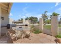 A patio area features a built-in grill, dining table, and stone flooring at 11465 N 56Th St, Scottsdale, AZ 85254