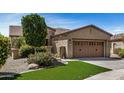 Attractive home showcasing desert landscaping, a gated front patio, and a spacious two-car garage at 12353 W Running Deer Trl, Peoria, AZ 85383