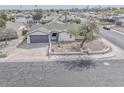 Charming single-story home featuring a well-manicured front yard and an attached two-car garage at 15243 N 52Nd Dr, Glendale, AZ 85306