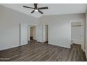 Spacious main bedroom featuring wood floors, ensuite bath and ceiling fan at 15346 W Hearn Rd, Surprise, AZ 85379