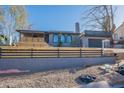 Street view of this updated home with a two-car garage, unique arched windows, and desert-style landscaping at 1637 E Camino Del Santo --, Phoenix, AZ 85022