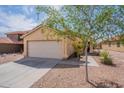 Inviting home exterior with desert landscaping, a two-car garage, and a walkway to the front door at 168 S 223Rd Dr, Buckeye, AZ 85326