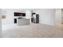 Modern kitchen with stainless steel appliances and center island provides ample counter space at 1854 W Sombra Ave, Apache Junction, AZ 85120