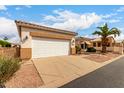 Spacious two-car garage with a white door and tan trim at 2101 S Meridian Rd # 26, Apache Junction, AZ 85120