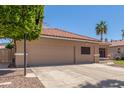 Single-Gathering home with attached two-car garage, concrete driveway, and desert landscaping at 21313 N 59Th Dr, Glendale, AZ 85308