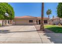 Single-Gathering home with attached two-car garage, concrete driveway, and desert landscaping at 21313 N 59Th Dr, Glendale, AZ 85308