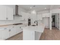 Modern kitchen with white cabinets, stainless steel appliances, and a spacious quartz countertop island at 21846 E Bonanza Ct, Queen Creek, AZ 85142