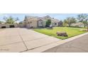 Inviting home featuring a spacious driveway and lush green lawn at 23455 S 199Th Pl, Queen Creek, AZ 85142