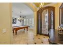 Welcoming foyer with a decorative front door and a glimpse into the billiard room at 23455 S 199Th Pl, Queen Creek, AZ 85142