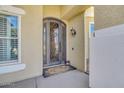 Elegant front door with ornate iron detailing and decorative sidelight at 23455 S 199Th Pl, Queen Creek, AZ 85142