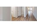Hallway with doors leading to different rooms featuring wood-look vinyl flooring at 2509 W Seaver Ave, Apache Junction, AZ 85120