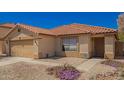 Charming single-story home with a well-maintained yard, two-car garage, and desert landscaping at 252 S Canfield --, Mesa, AZ 85208