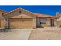 Home with a spacious two-car garage and well-kept desert landscaping at 252 S Canfield --, Mesa, AZ 85208
