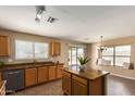 Functional kitchen featuring tile floors, oak cabinets, granite countertops, and a center island at 252 S Canfield --, Mesa, AZ 85208