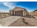 View of house with desert landscaping, two car garage, and light colored brick driveway at 25308 N 133Rd Ave, Peoria, AZ 85383