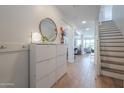 Bright entryway featuring tile floors, white walls, modern storage solutions, and staircase access at 277 W Glacier Bay Dr, San Tan Valley, AZ 85140