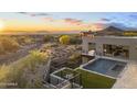 Modern home featuring a pool, spa, artificial turf, and desert landscaping at 29599 N 106Th Pl, Scottsdale, AZ 85262