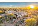 Desert home featuring beautiful landscaping and mountain views at sunset at 32806 N 55Th Pl, Cave Creek, AZ 85331