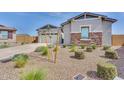 Well-maintained home featuring desert landscaping, a stone facade, and a two-car garage enhancing its curb appeal at 3347 E Malibu Dr, San Tan Valley, AZ 85143