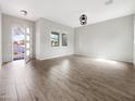 Spacious living room with wood-look tile flooring, ample natural light, and neutral color palette at 4171 E Ronald St, Gilbert, AZ 85295