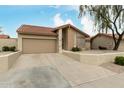 Charming one-story home featuring a tile roof, two-car garage, and desert landscaping at 4436 E Shomi St, Phoenix, AZ 85044