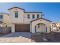Stylish two-story home with a brown garage door and an inviting arched entryway, complemented by well-maintained landscaping at 560 W Copper Way, Chandler, AZ 85225