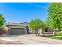 Beautiful home with a spacious driveway, a well-maintained lawn, and mature trees providing shade at 579 E Mary Ct, Gilbert, AZ 85295