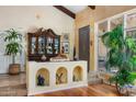 Elegant living room featuring hardwood floors, a display cabinet, and lots of light at 6301 N Camelback Manor Dr, Paradise Valley, AZ 85253