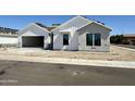 Charming new construction home featuring bright white siding and a spacious two car garage at 6460 E Omega Cir, Mesa, AZ 85215