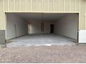 A spacious garage featuring a smooth concrete floor and drywall that is ready for paint and finish at 6460 E Omega Cir, Mesa, AZ 85215