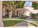 Secluded backyard with lush landscaping, beautiful trees, and a charming stone walkway at 7630 E Vaquero Dr, Scottsdale, AZ 85258