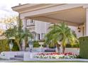 Grand entrance showing meticulously landscaped flowers and plants leading up to a covered portico at 7630 E Vaquero Dr, Scottsdale, AZ 85258