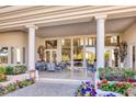 Spacious covered patio with elegant seating, lush flowers, and great views of the interior at 7630 E Vaquero Dr, Scottsdale, AZ 85258