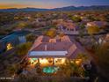Luxury home with a private pool and outdoor living area, nestled in a scenic desert landscape with distant mountains at 8427 E Preserve Way, Scottsdale, AZ 85266