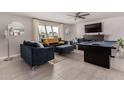 A spacious living room with an entertainment center, pool table, and modern furniture at 8750 E Starlight Way, Scottsdale, AZ 85250