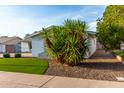 A side view of a single story home with gravel landscaping and mature vegetation at 8750 E Starlight Way, Scottsdale, AZ 85250