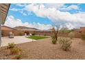 Landscaped backyard with patio, artificial turf, and lounge seating perfect for relaxing at 8751 S 168Th Dr, Goodyear, AZ 85338