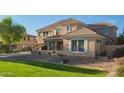 Charming home with a stone facade, well-manicured lawn, and a tiered landscape design at 950 E Desert Inn Dr, Chandler, AZ 85249
