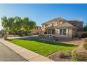 Well-maintained home features a green lawn, mature trees, and neutral-toned exterior at 950 E Desert Inn Dr, Chandler, AZ 85249