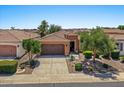 Charming single-story home featuring a well-manicured front yard and a two-car garage at 1449 E Artemis Trl, Queen Creek, AZ 85140