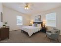 Well-lit bedroom with a queen bed, soft carpet, and large windows for natural light at 2929 E Sequoia Dr, Phoenix, AZ 85050